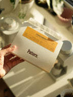 Hand holding a package with 'Pattern' and 'Chocoberry' branding.